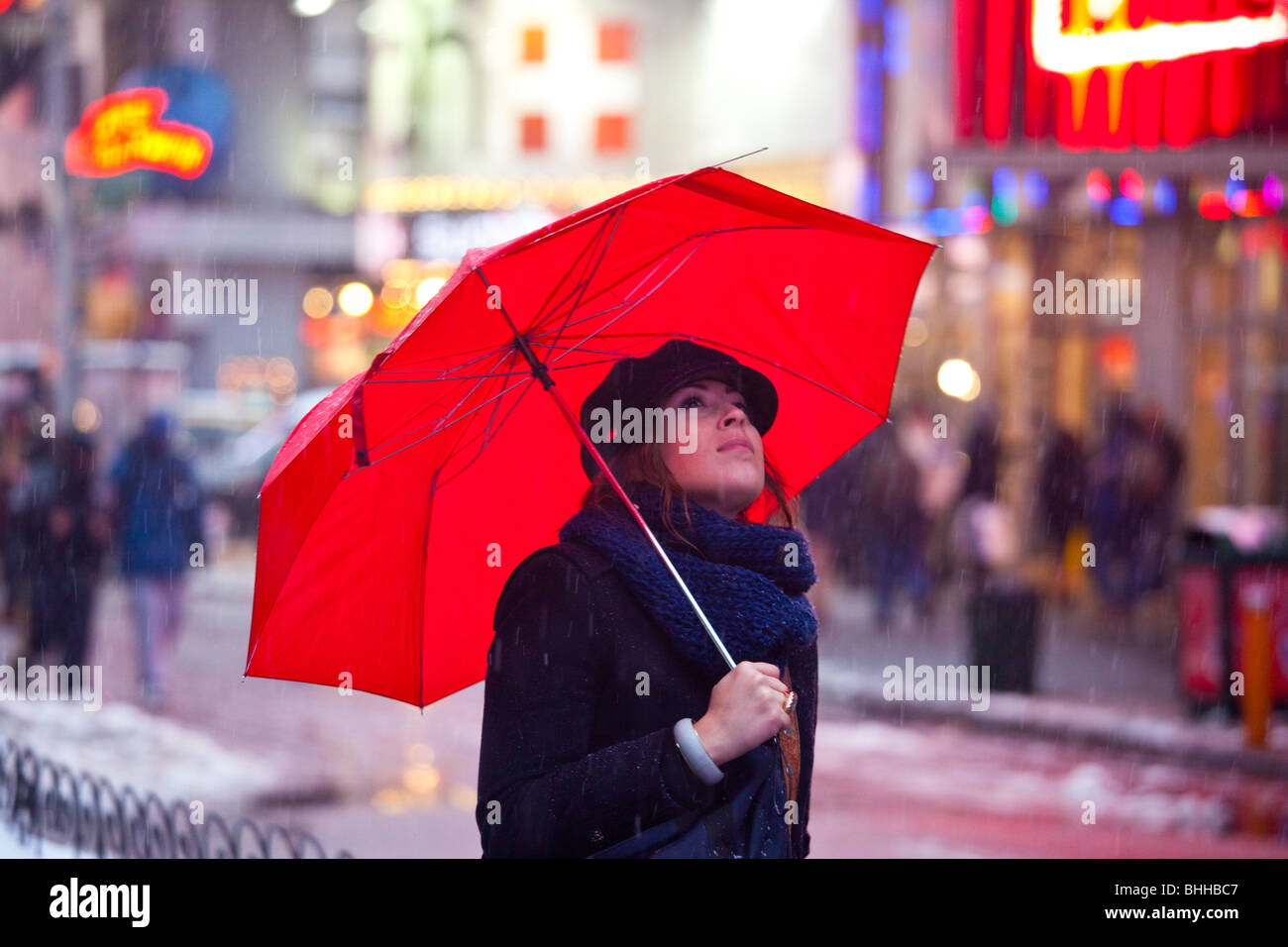 Snowing on a woman in Times Square, New York City Stock Photo