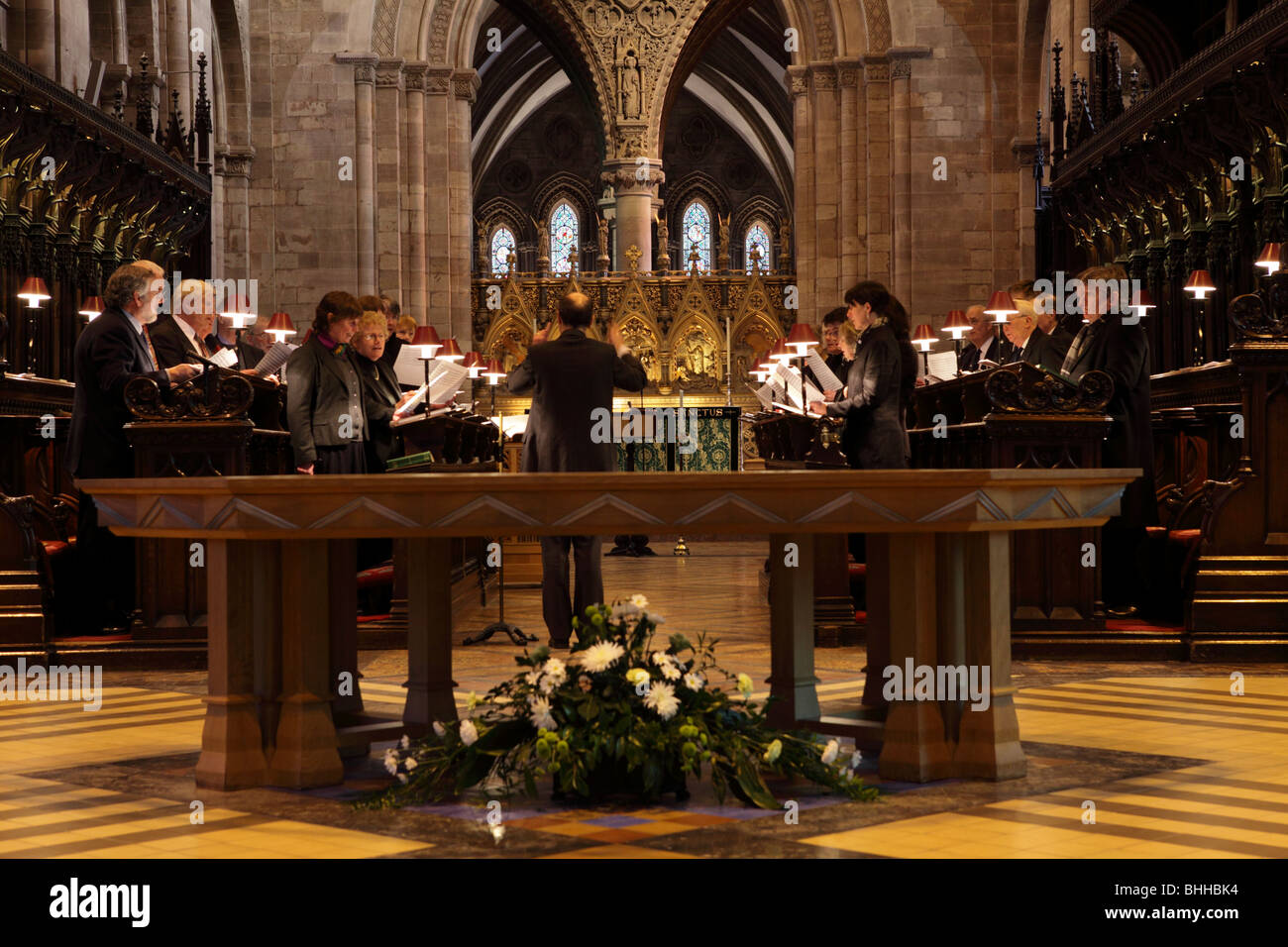 Choir practice at Hereford Cathedral before Evensong,the Altar Table in the foreground. Stock Photo