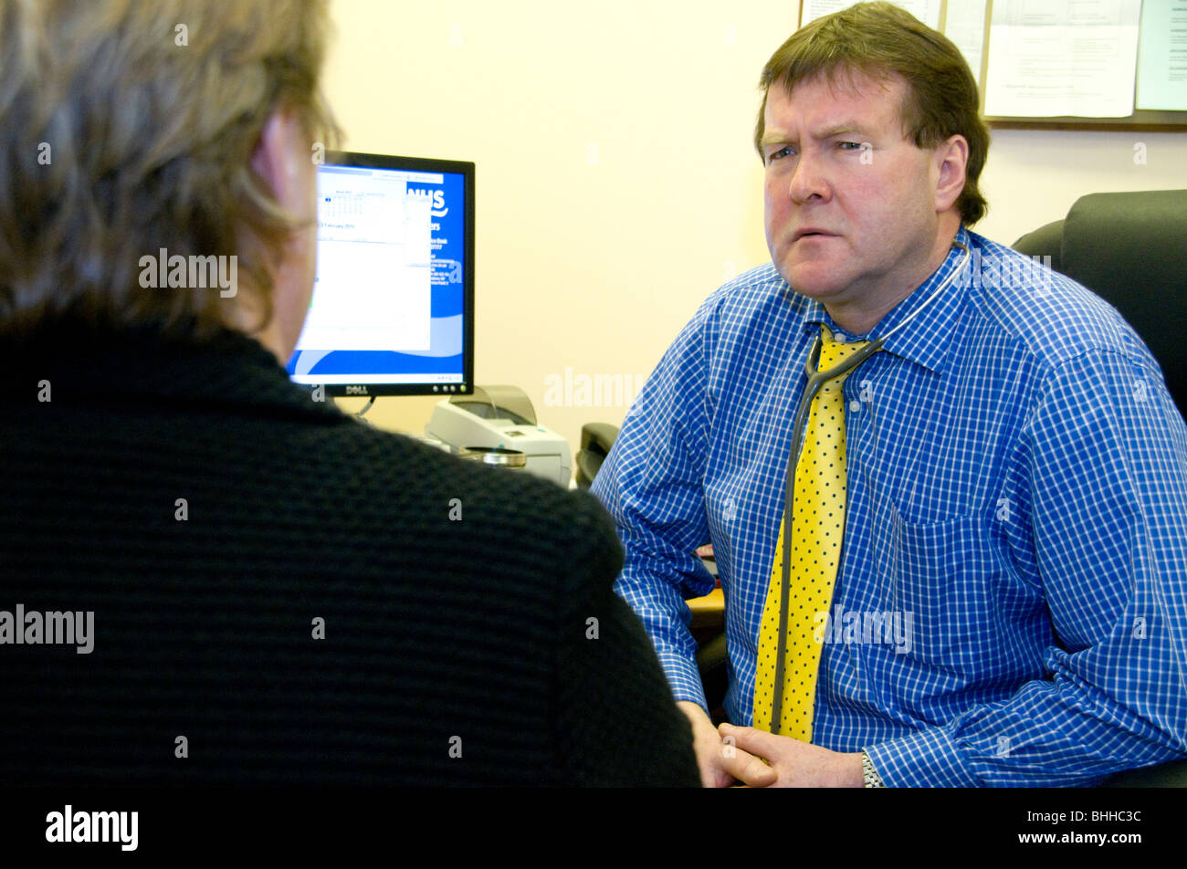 A GP seeing a patient in a NHS surgery in the UK Stock Photo