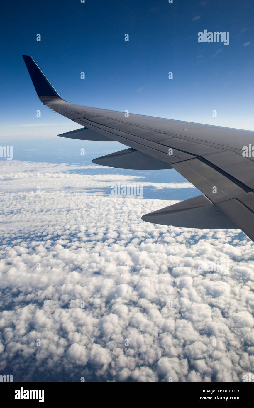 The wing of an aeroplane and blue sky. Stock Photo