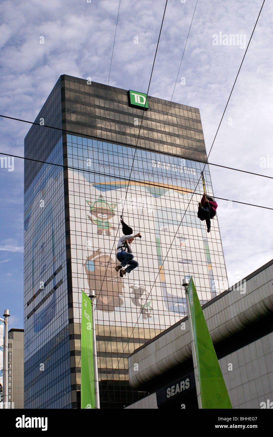 Person ziplining over Robson Square in downtown Vancouver, 2010 Winter Olympic Games, Vancouver, British Columbia, Canada. Stock Photo