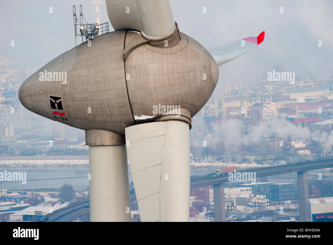 Germany Hamburg - Enercon wind turbine E-126 with 6 MW in harbour and view on Hamburg City Stock Photo
