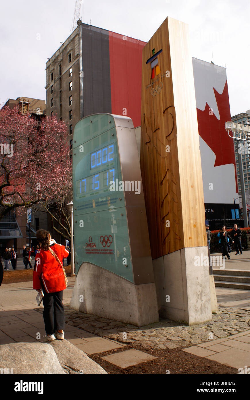 Girl looking at the official Olympic clock for the 2010 Winter Games, Vancouver, British Columbia, Canada. Stock Photo