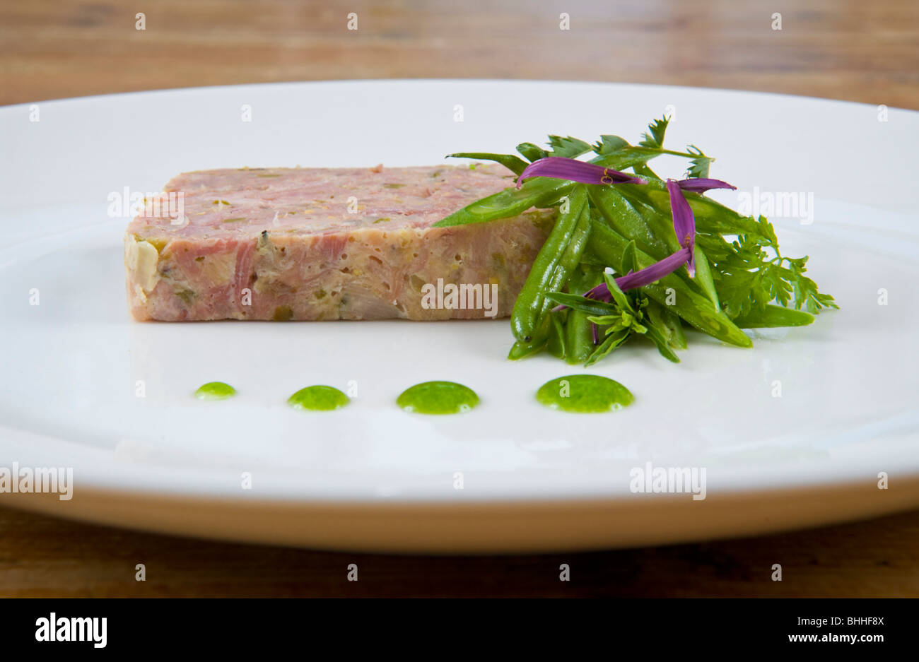 Ham Hock Terrine on white plate at The Felin Fach Griffin restaurant, near Brecon, Powys, Wales, UK Stock Photo