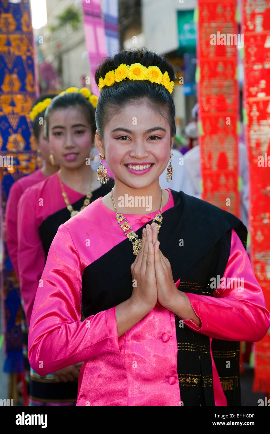 Wai buddhist greeting, respect, culture Thai cultural female asian woman dancer, portrait, traditional, flower art, clasped hand gesture Thailand. Stock Photo