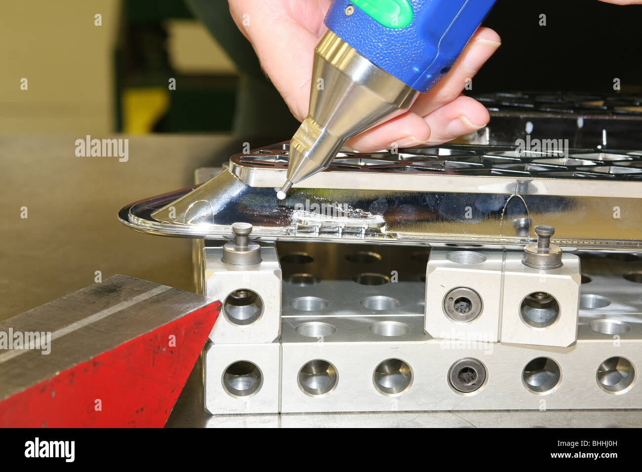 Using a measuring tool to compare a component's dimensions with the