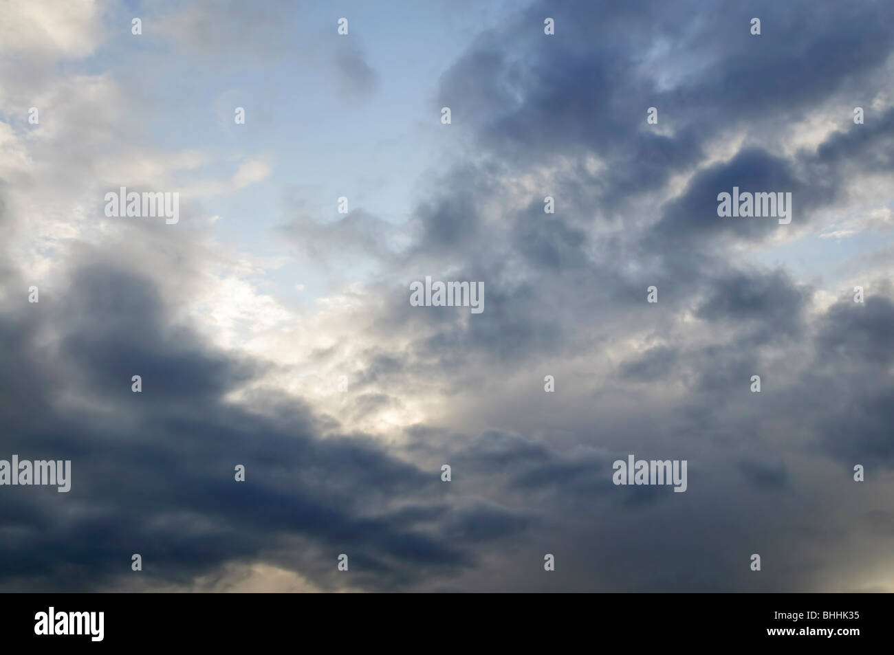Stormy weather sky with sun shining through clouds Stock Photo - Alamy