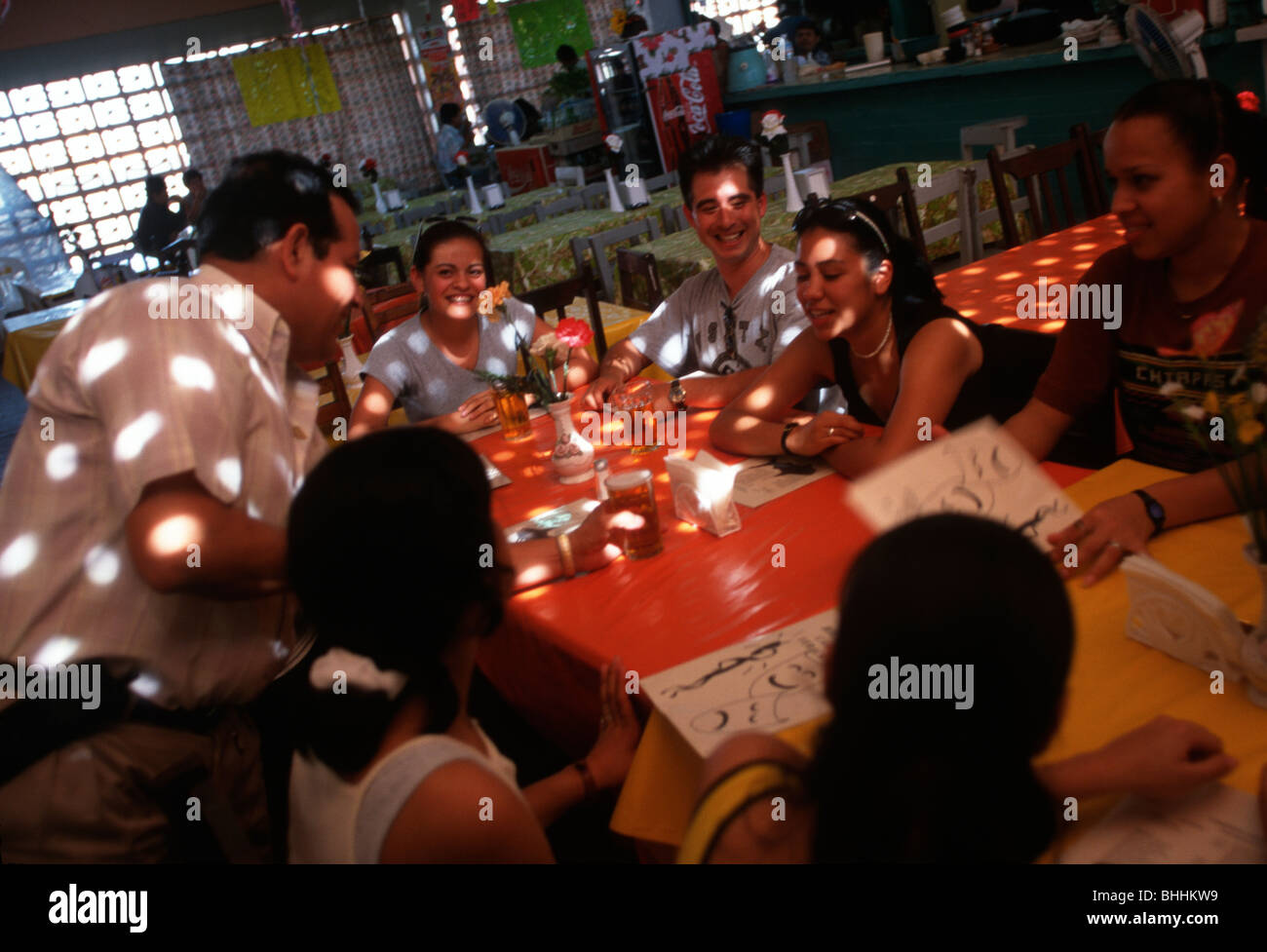 Young Mexicans ordering a meal in the restaurant above the fish market, Veracruz, Mexico. Stock Photo