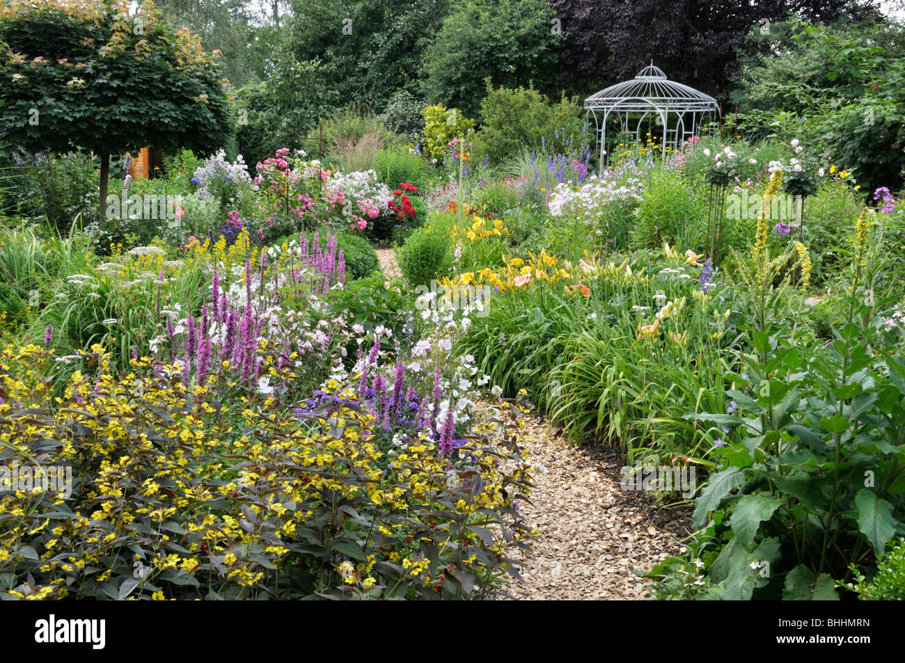 Rich flowering garden with pavilion. Design: Marianne and Detlef Lüdke Stock Photo