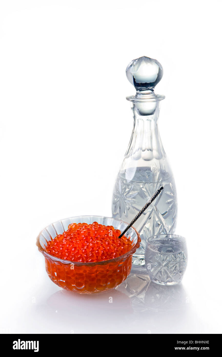 Crystal Decanter with vodka and capacity with red caviar Stock Photo