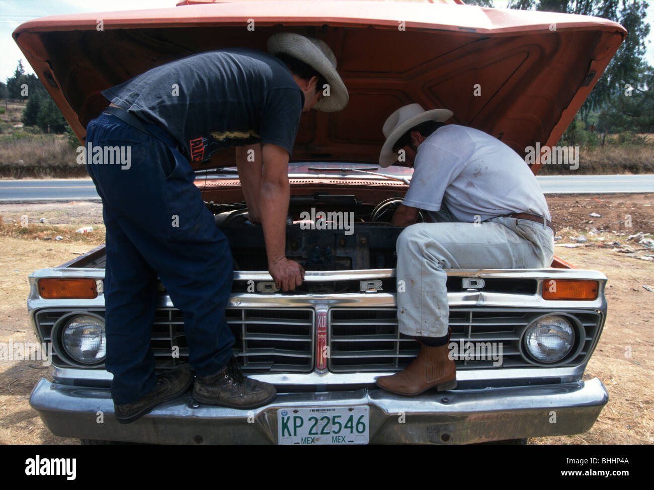 two-car-mechanics-wearing-cowboy-hats-re