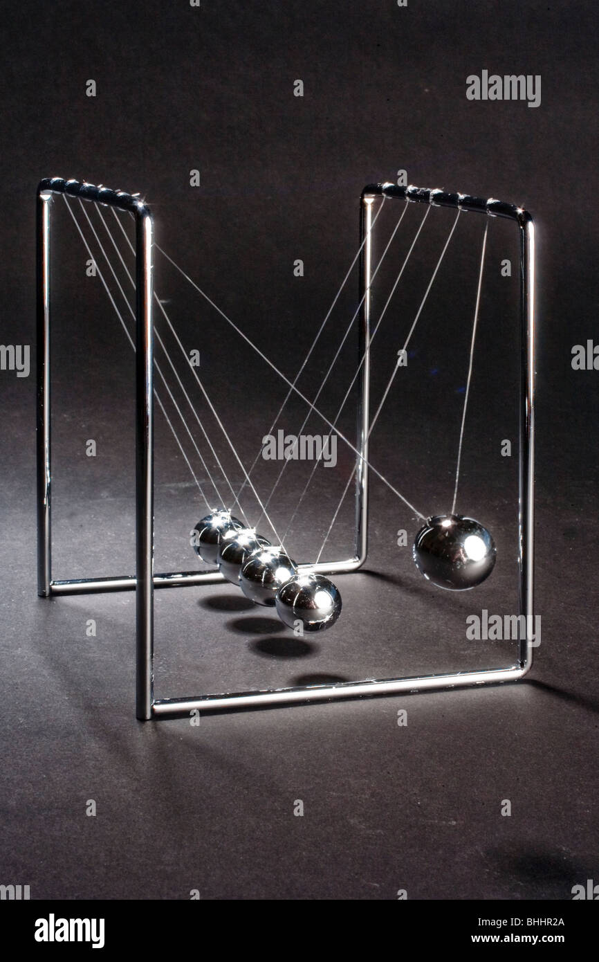 Newton s cradle named after Sir Isaac Newton is a device that demonstrates conservation of momentum and energy Stock Photo Alamy