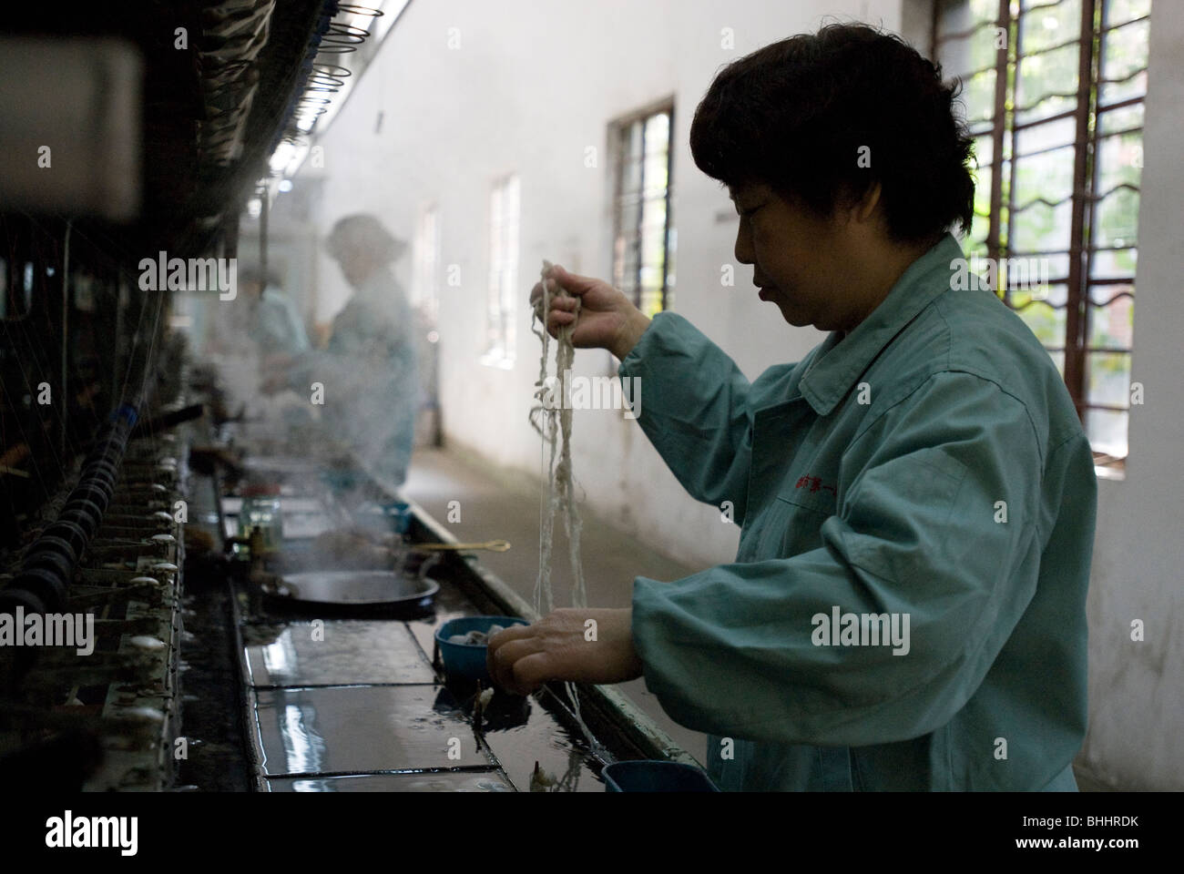 Unraveling silk from cocoons at the Suzhou No. 1 Silk Factory, Suzhou, Jiangsu province, China Stock Photo