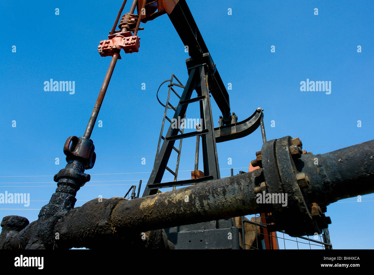 An oil well pump with the pipeline on the shore of the Maracaibo lake, Venezuela. Stock Photo