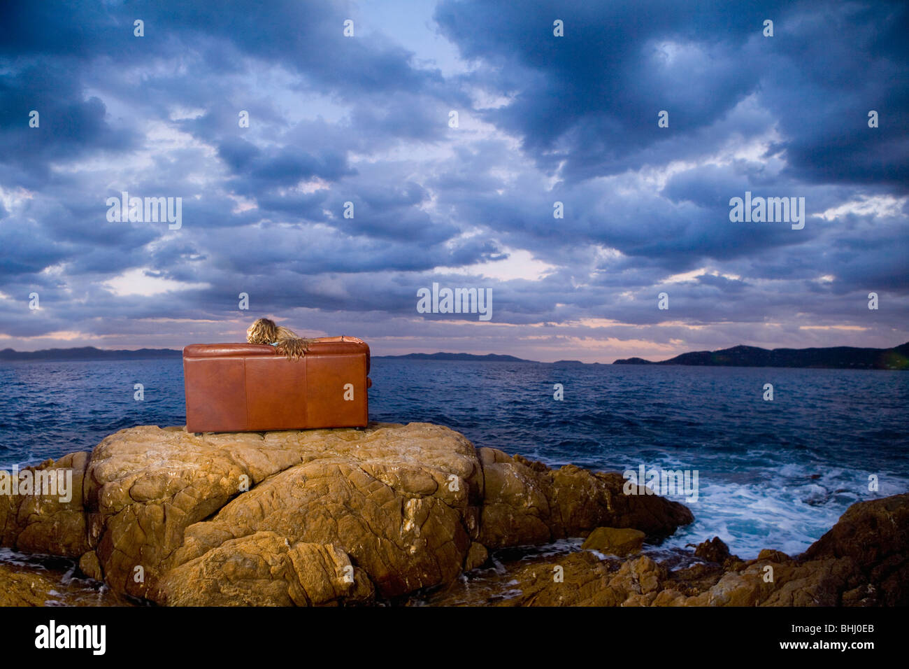 romantic couple on couch at rock beach Stock Photo