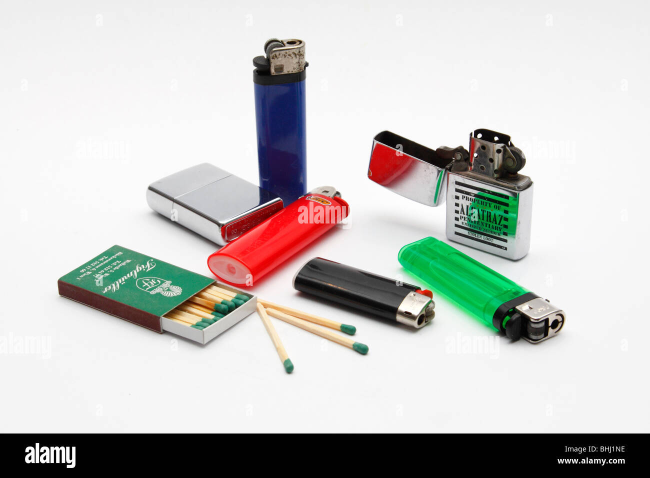 Lighters and matches on a white background. Stock Photo