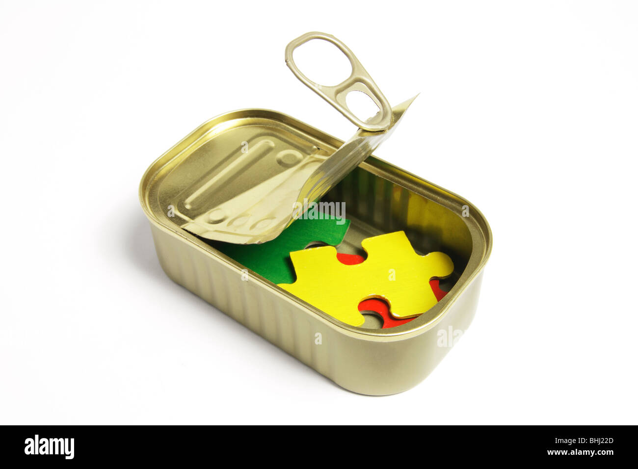 Jigsaw Puzzle Pieces in Tin Can Stock Photo