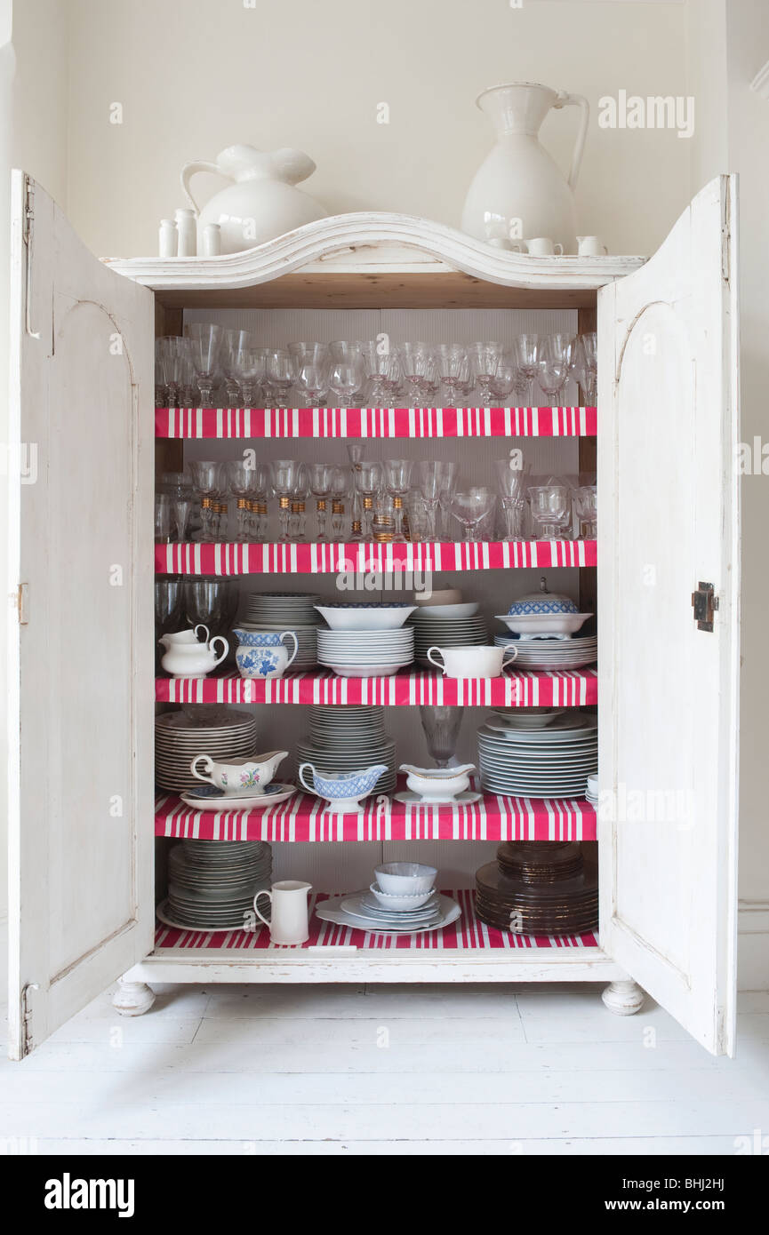 Open storage cupboard showing display of homeware Stock Photo