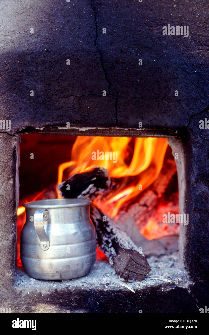 Coffee heating by a wood fired brick oven in central Mexico Stock Photo
