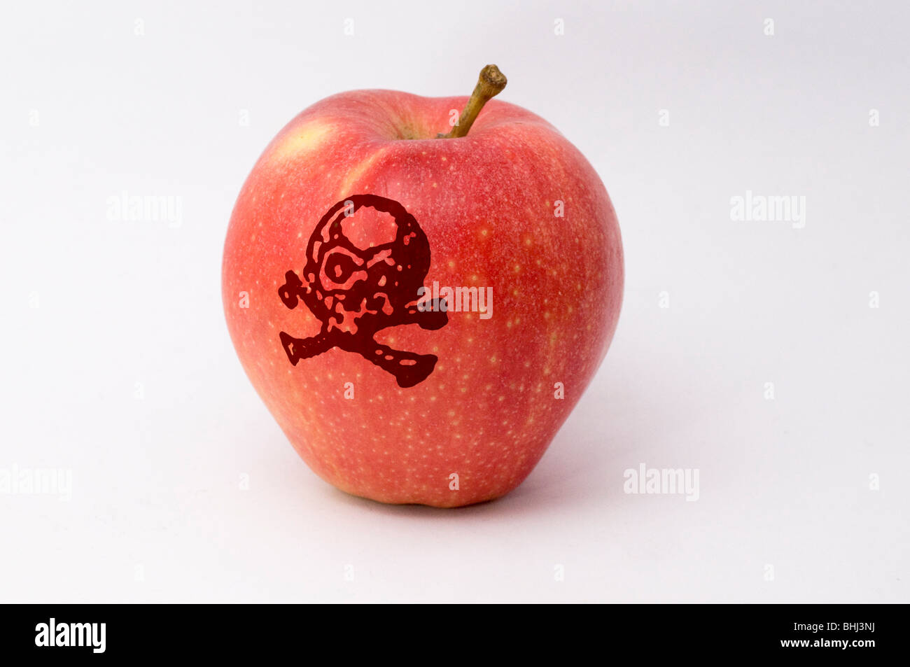 Poisonous apple a red apple with a poison sign imprinted on it Stock
