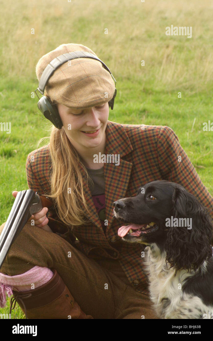 A Woman With A Shotgun And A Dog Stock Photo Alamy