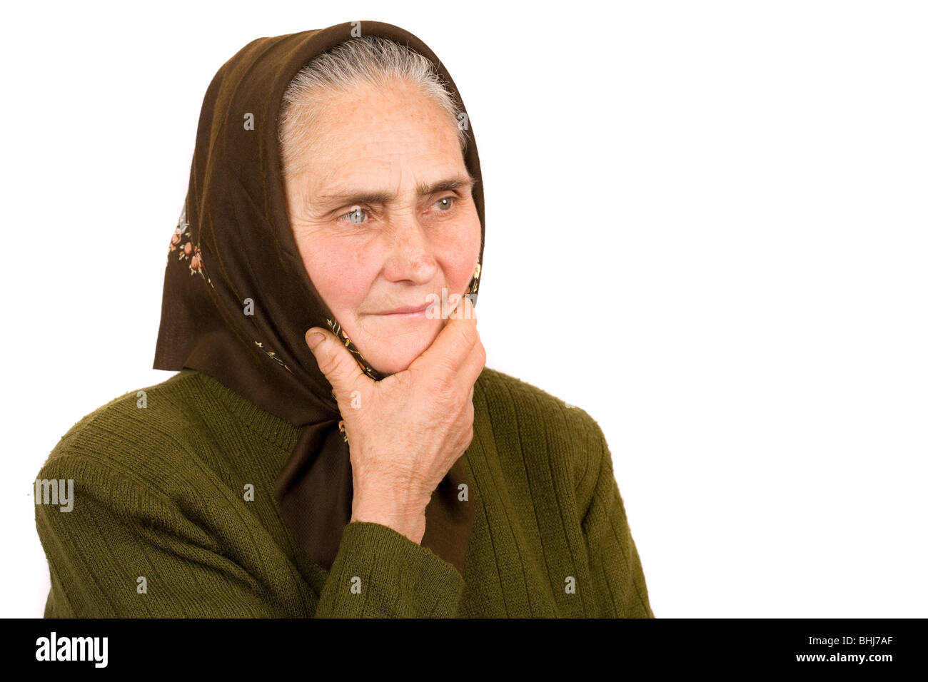 Close-up portrait of an old peasant woman isolated on white background 