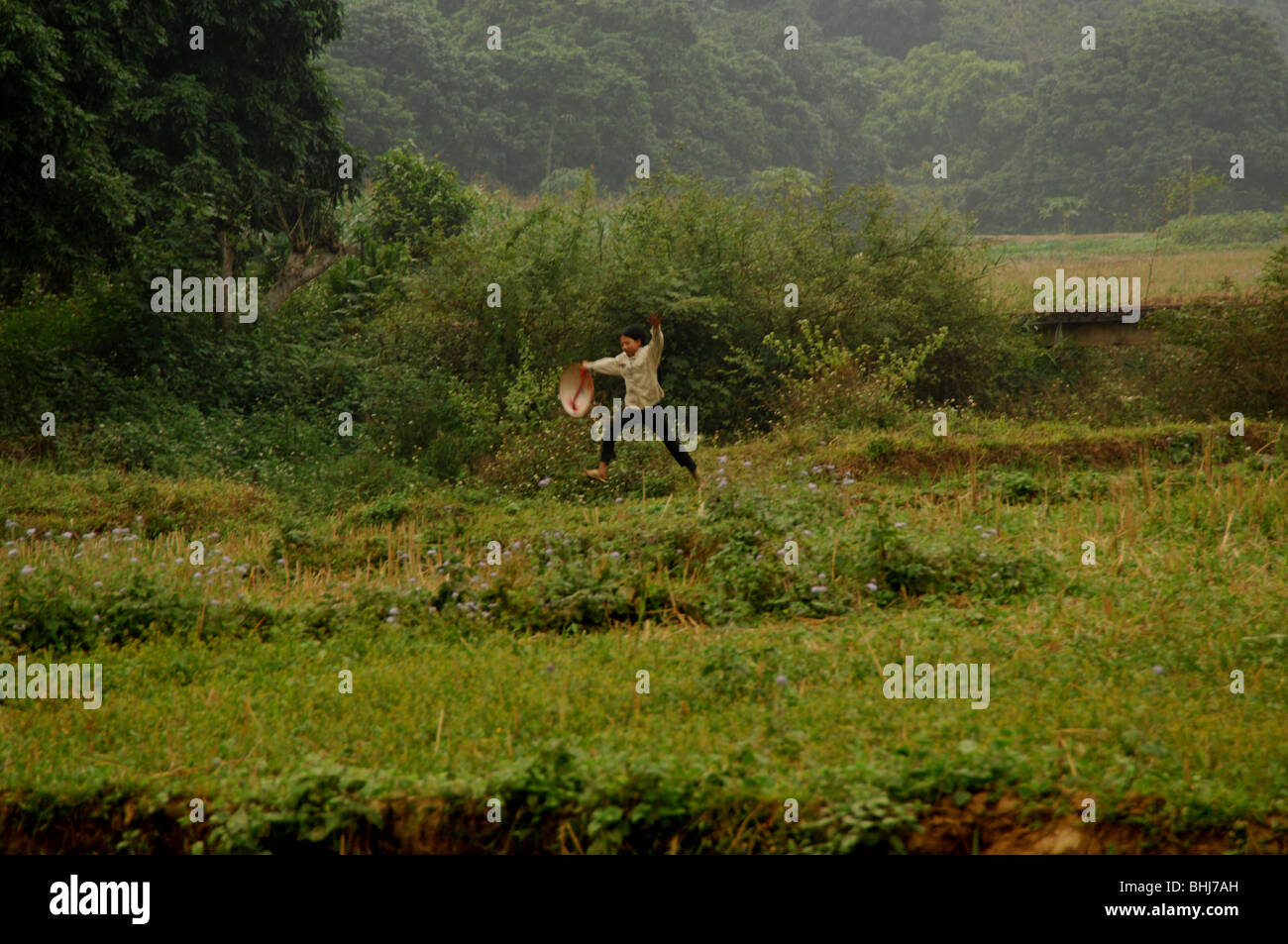 girl running through rice fields , road to coc ly , northwest Vietnam