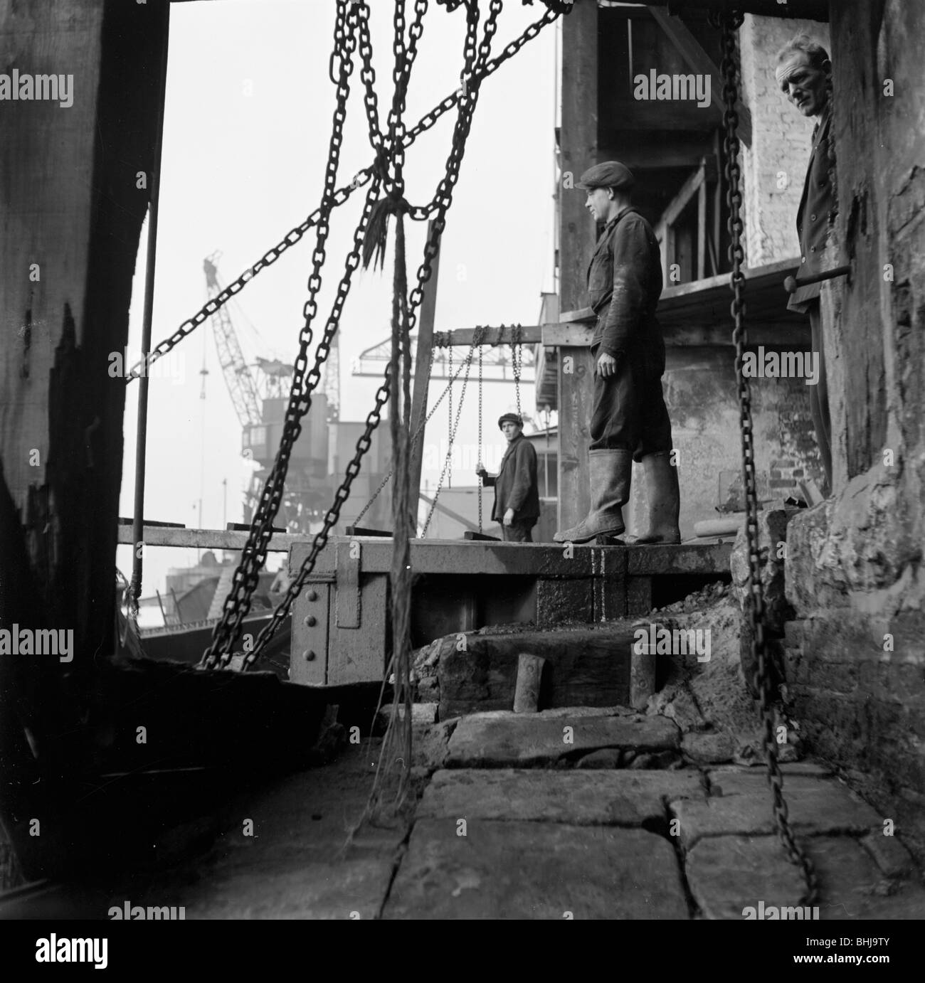 Men working at a wharf on the River Thames in Limehouse, London, c1945-c1965. Artist: SW Rawlings Stock Photo