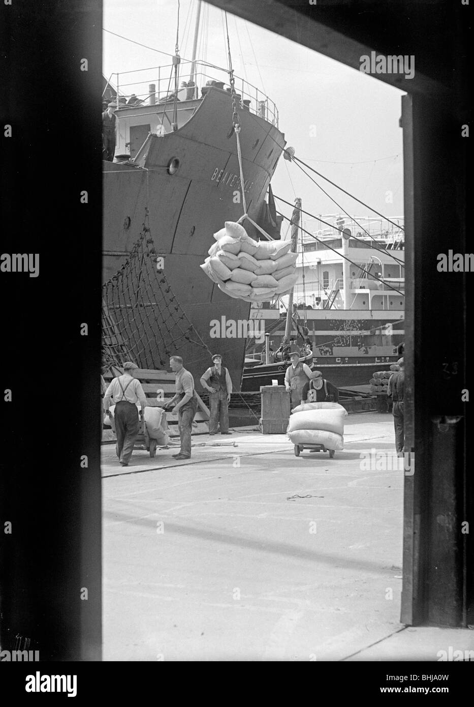 Sacks being loaded onto a ship in London docks, c1945-c1965. Artist: SW Rawlings Stock Photo