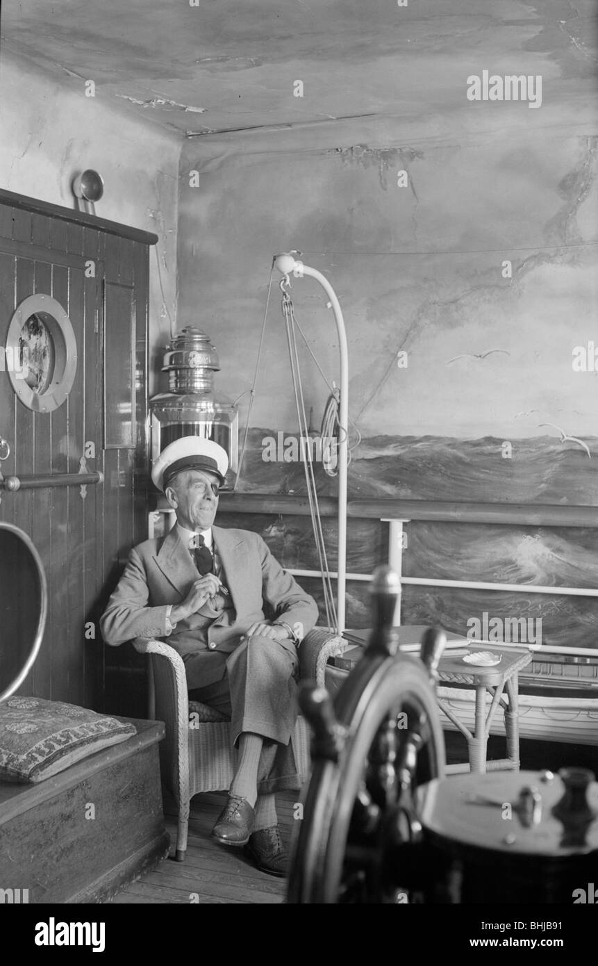 A man in a sailor's cap and eyepatch sits in a reconstructed ship's cabin, c1945-c1965. Artist: SW Rawlings Stock Photo
