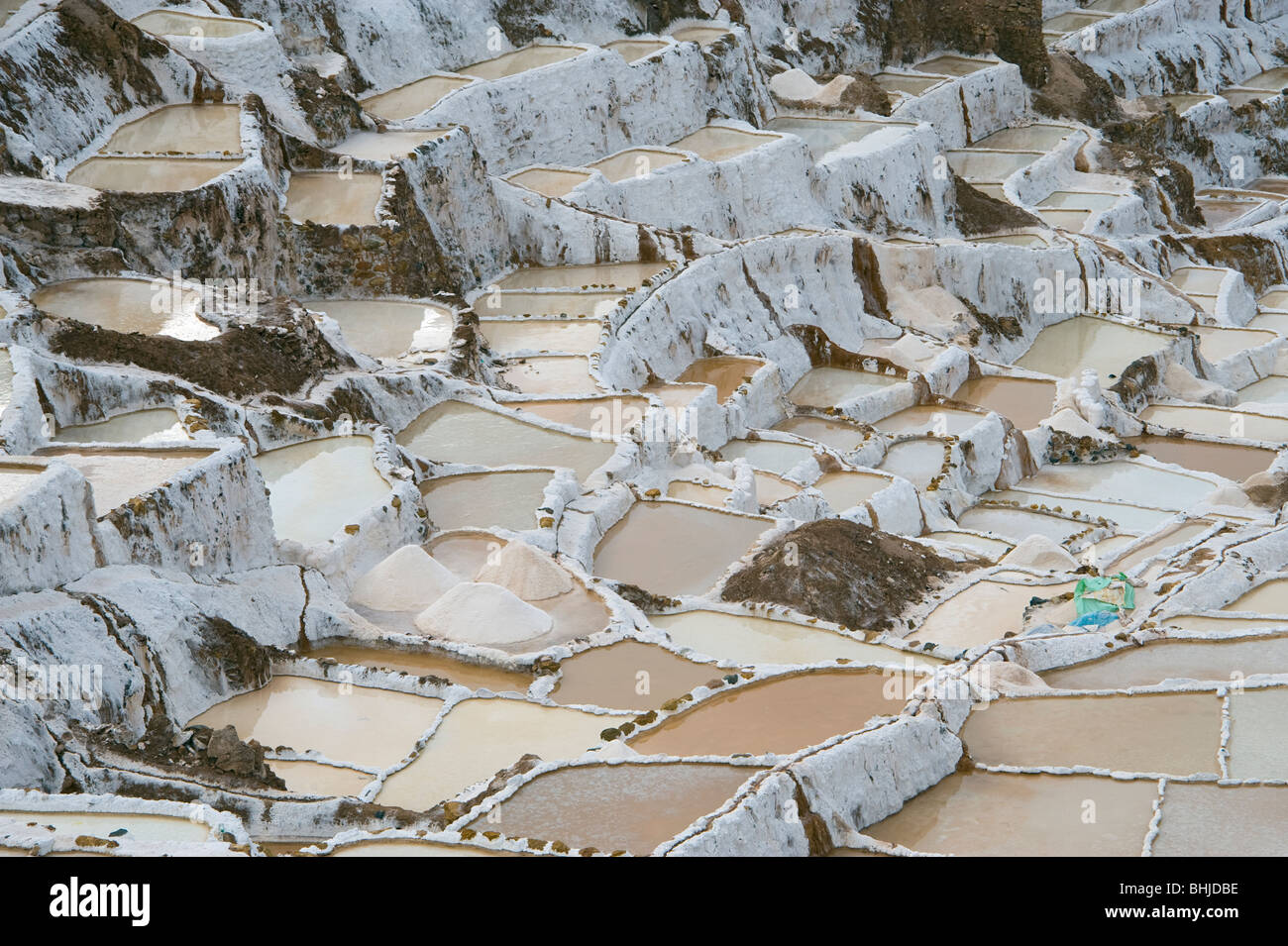 Piles of salt in the terraced salt pans at Maras, near Urubamba and Cuzco in Peru Stock Photo