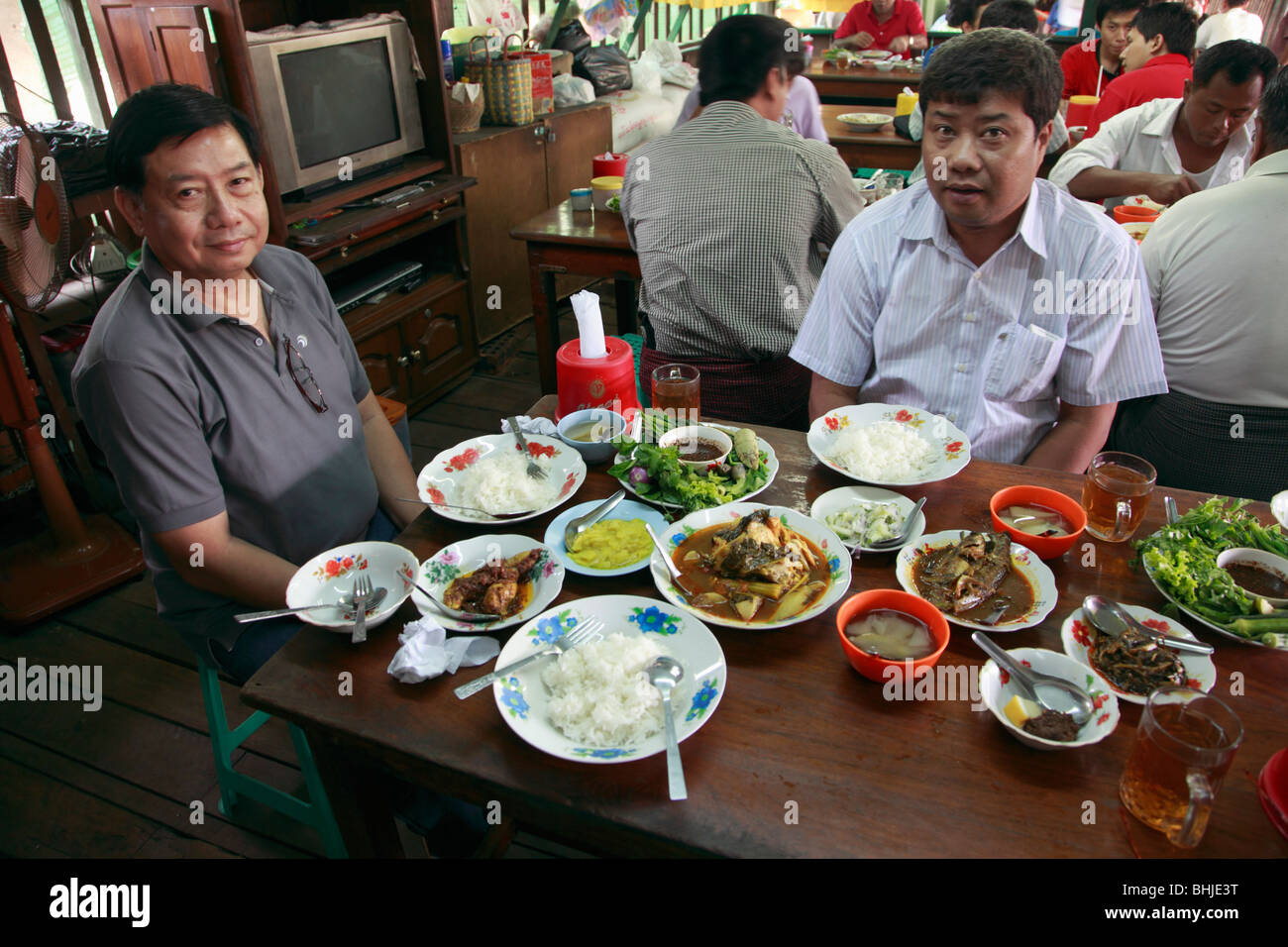Myanmar, Burma, Yangon, Rangoon, typical local meal, restaurant, people Stock Photo