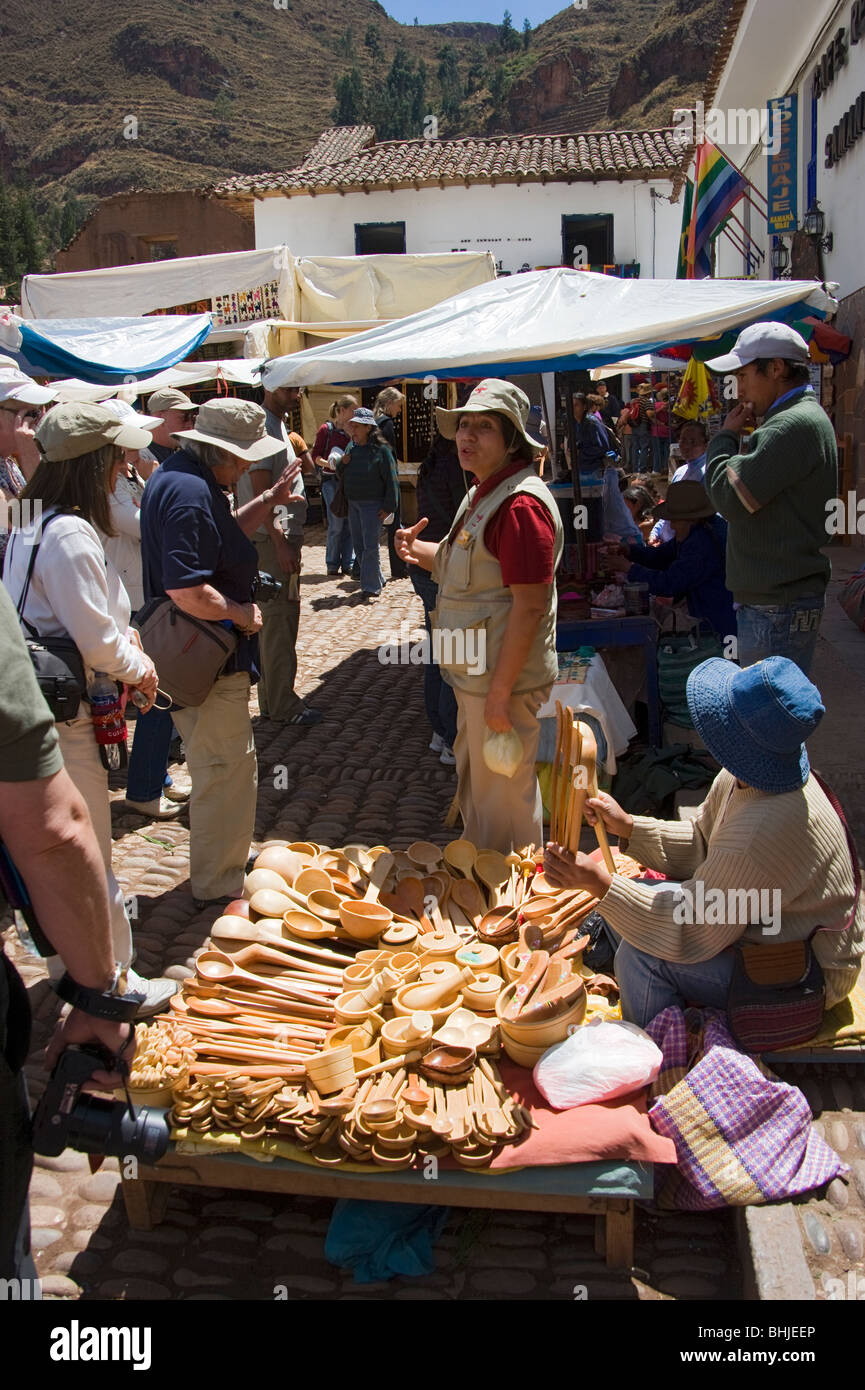 Local guide, Odelia talking to her tour group by the wooden spoon stall at Pisac market, Peru Stock Photo