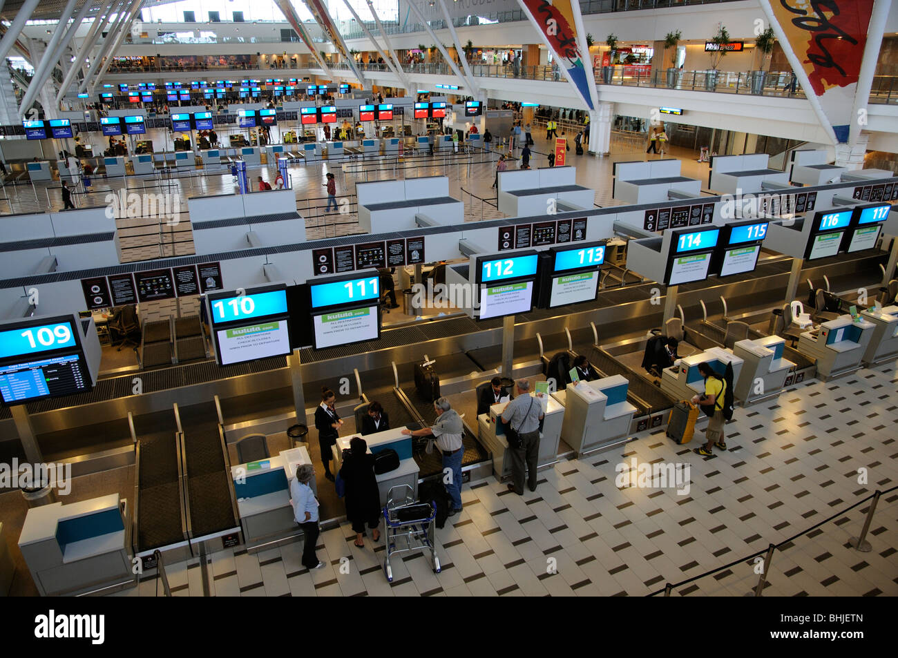 Passengers at Kulula airline check in desks Cape Town International Airport central terminal building Stock Photo