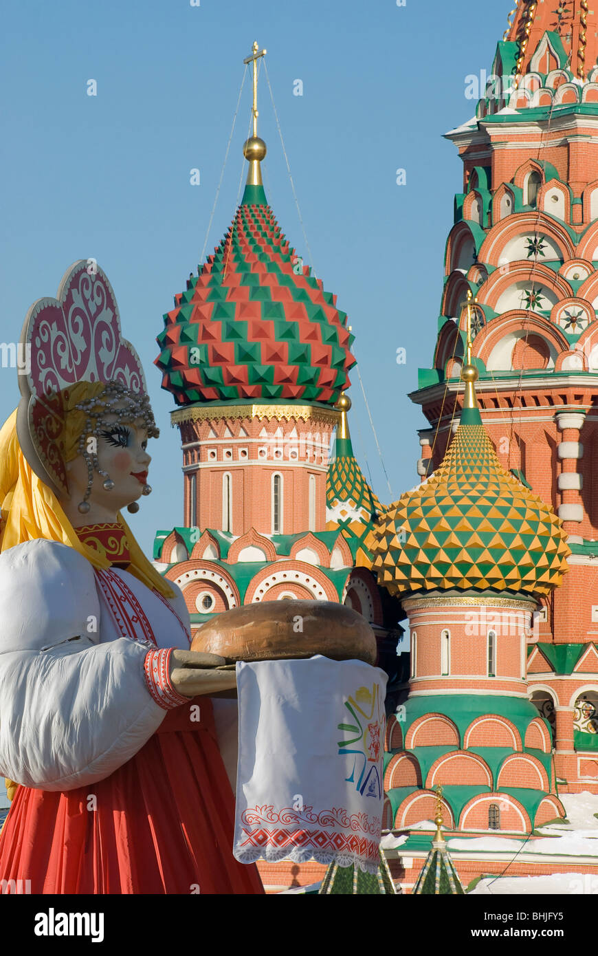 A Russian doll on the Towers of Moscow orthodox Saint-Basil cathedral background Stock Photo