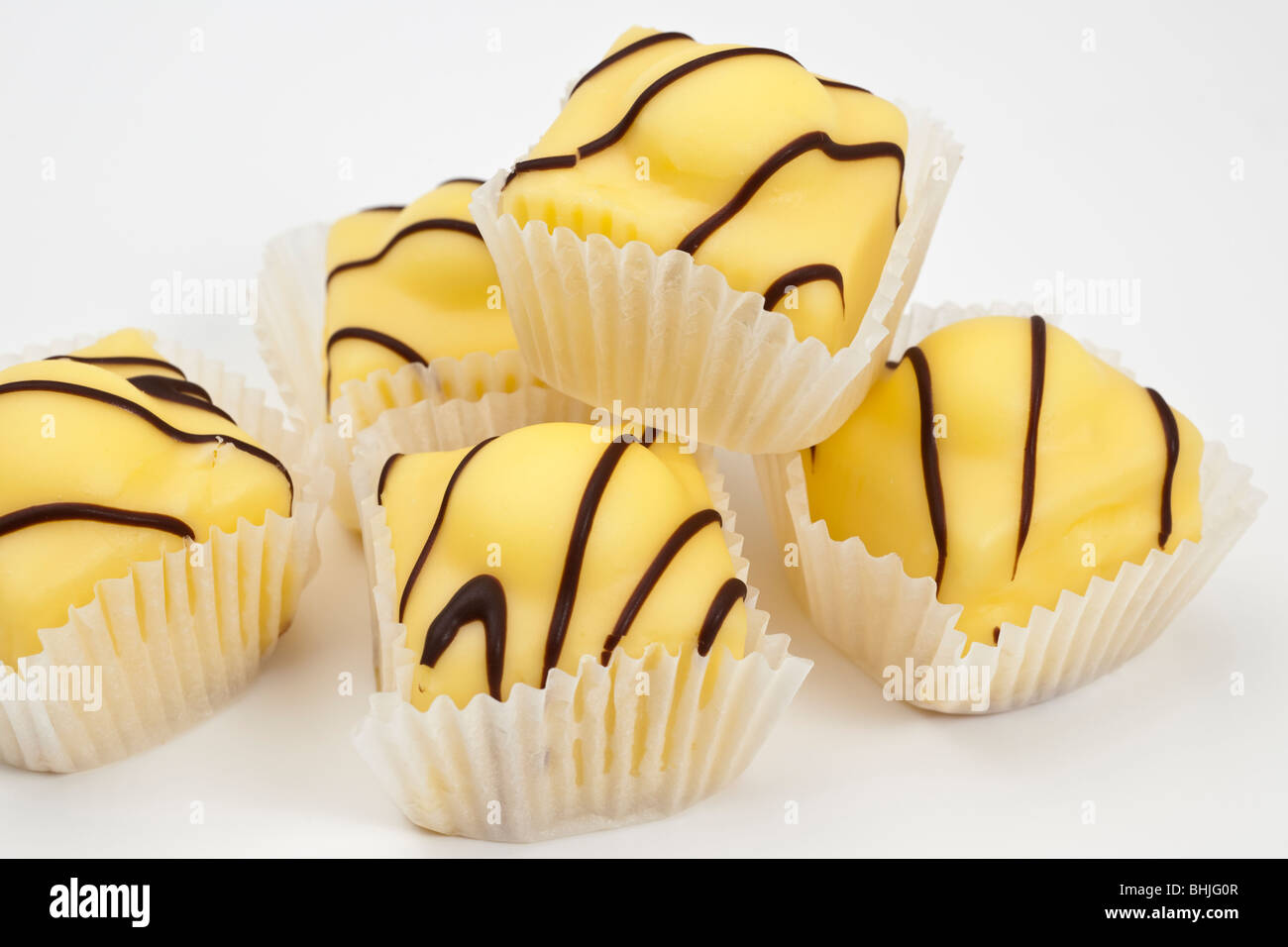 Five Mr Kipling Lemon French Fancies sponge cakes with vanilla topping Stock Photo