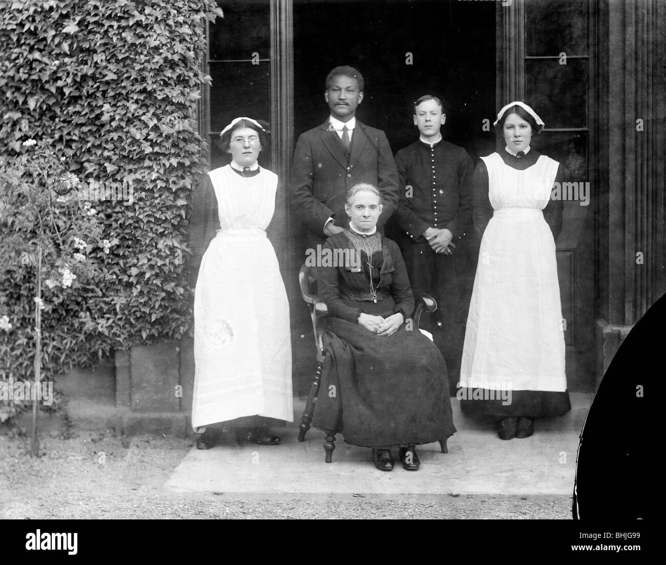 Domestic servants posing outside Pembroke College, Oxford, Oxfordshire, c1860-c1922. Artist: Henry Taunt Stock Photo