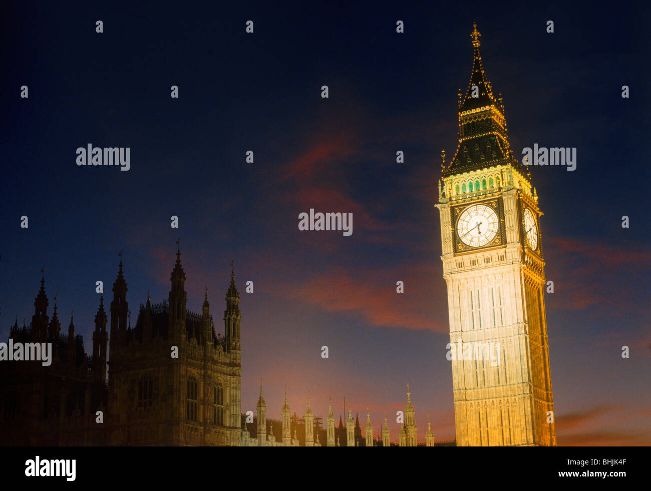 Big Ben standing above Westminster Bridge and River Thames in London at night Stock Photo