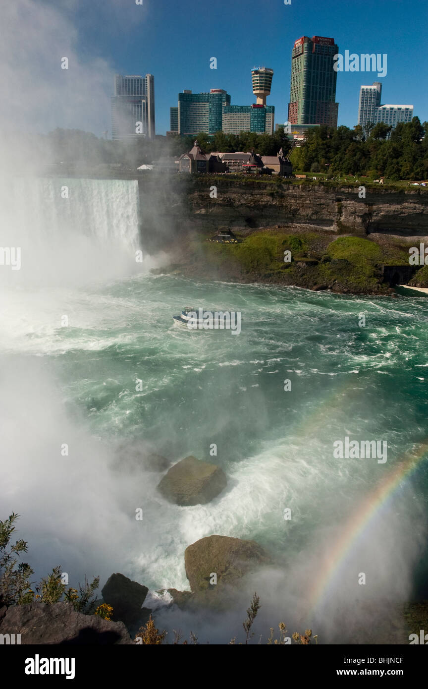 Rainbow, Horseshoe Falls and Canadian side buildings in the background, Niagara Falls, USA, CANADA Stock Photo