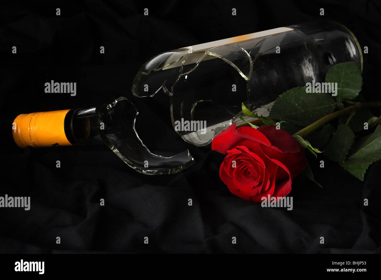 Broken wine bottle and a rose Stock Photo Alamy