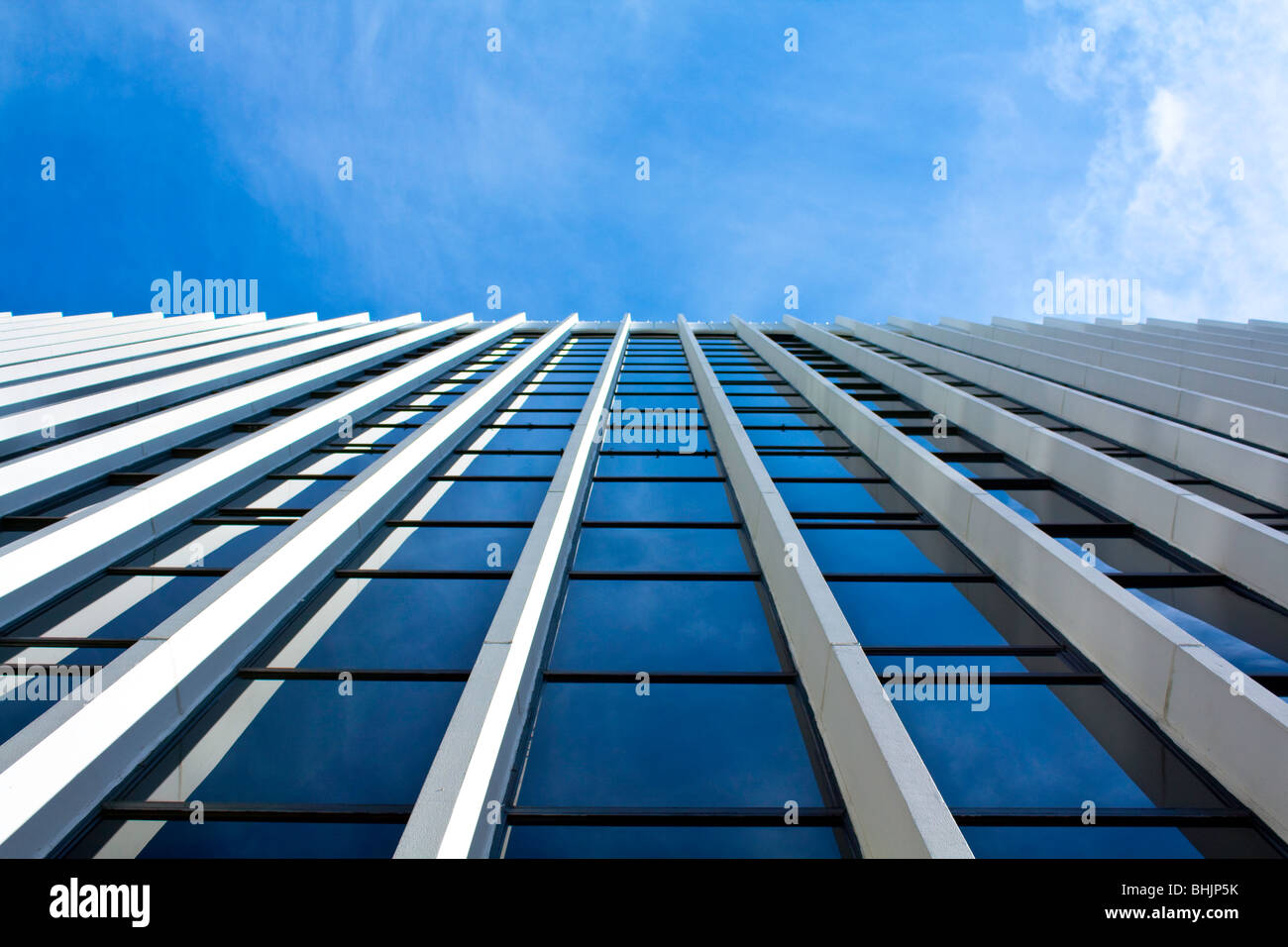Building looking up to cloudy blue sky and reflection Stock Photo - Alamy