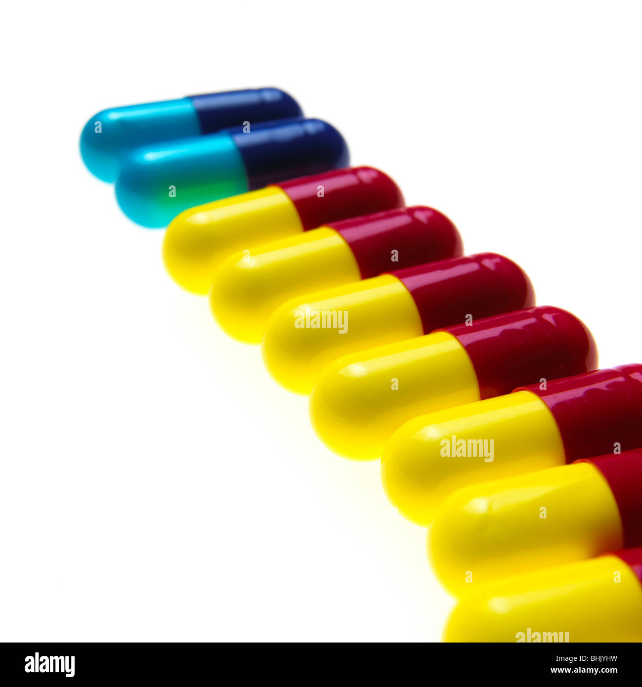 blue, red and yellow flu capsules on a white background Stock Photo