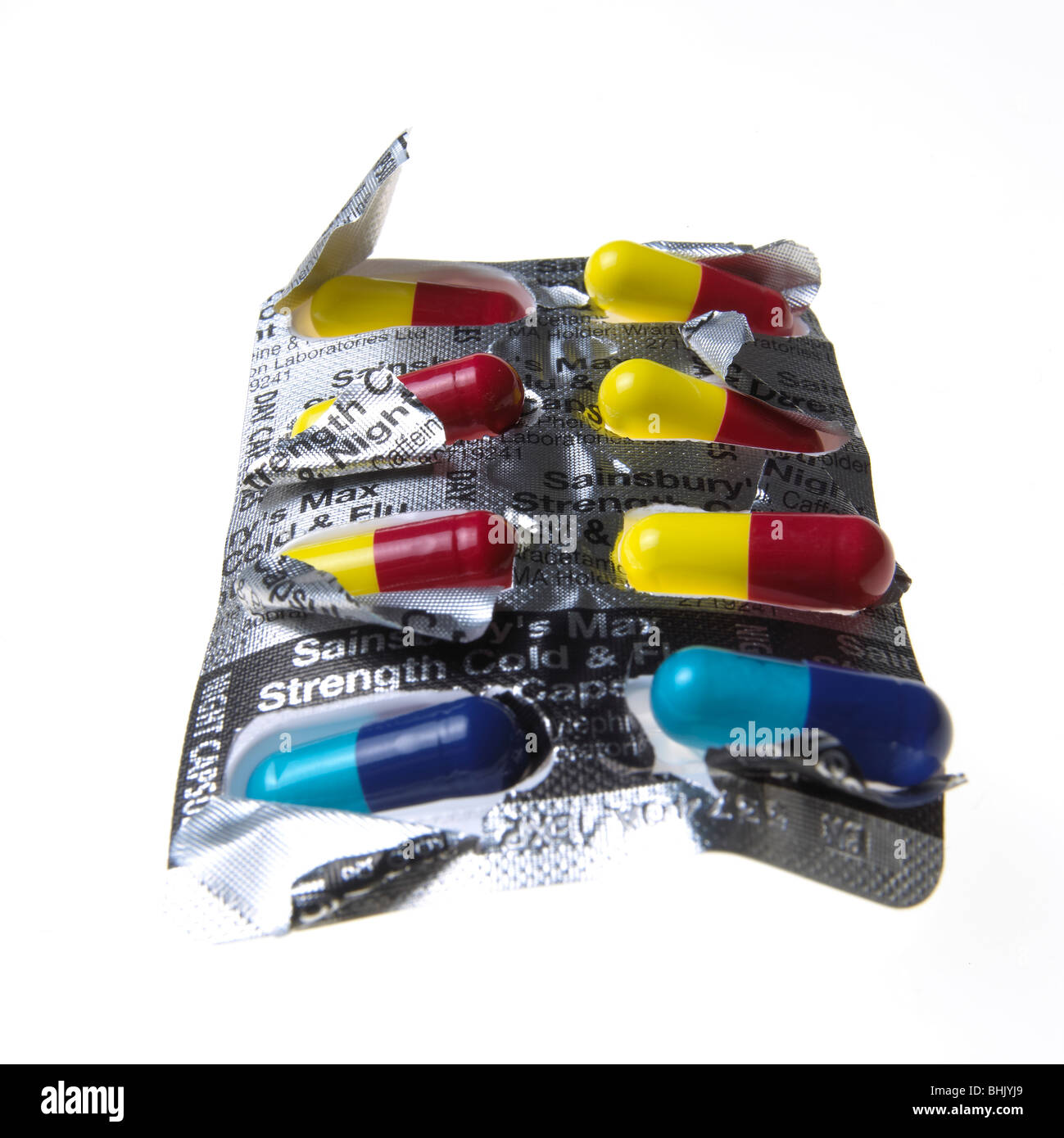 blue, red and yellow flu capsules on a white background Stock Photo