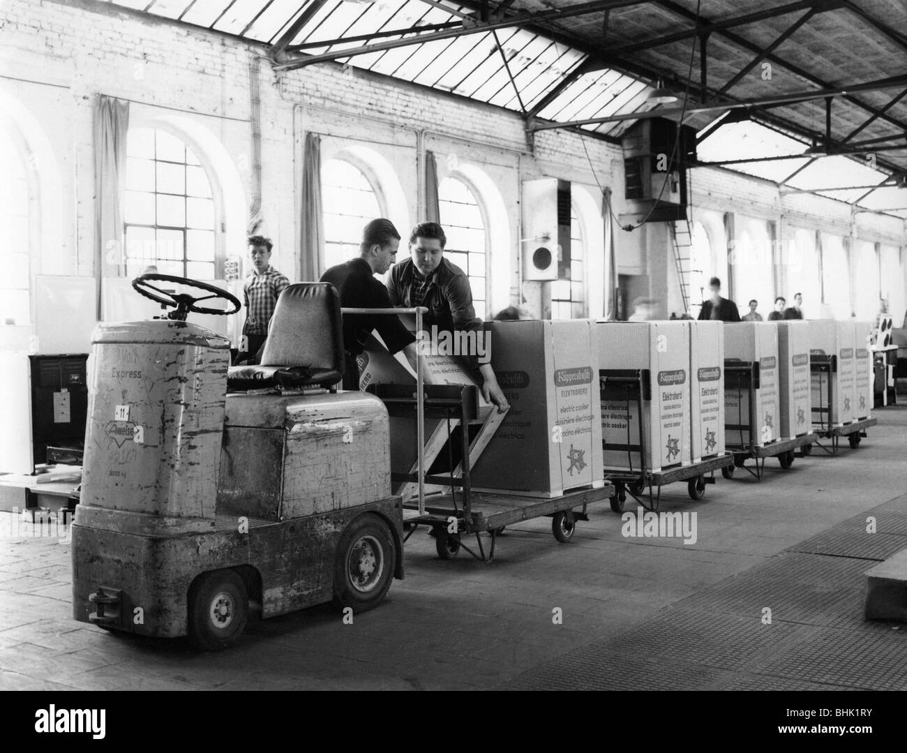 industry, factories, Kuepperbusch, worker loading up transport vehicle with boxes of electric range, Gelsenkirchen, Germany, circa 1960s, Stock Photo