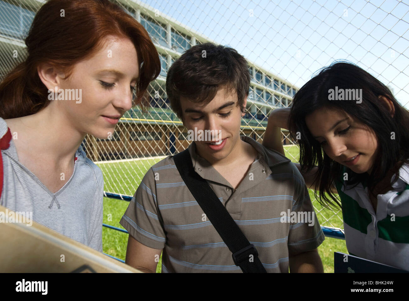 Teenage friends standing together chatting Stock Photo