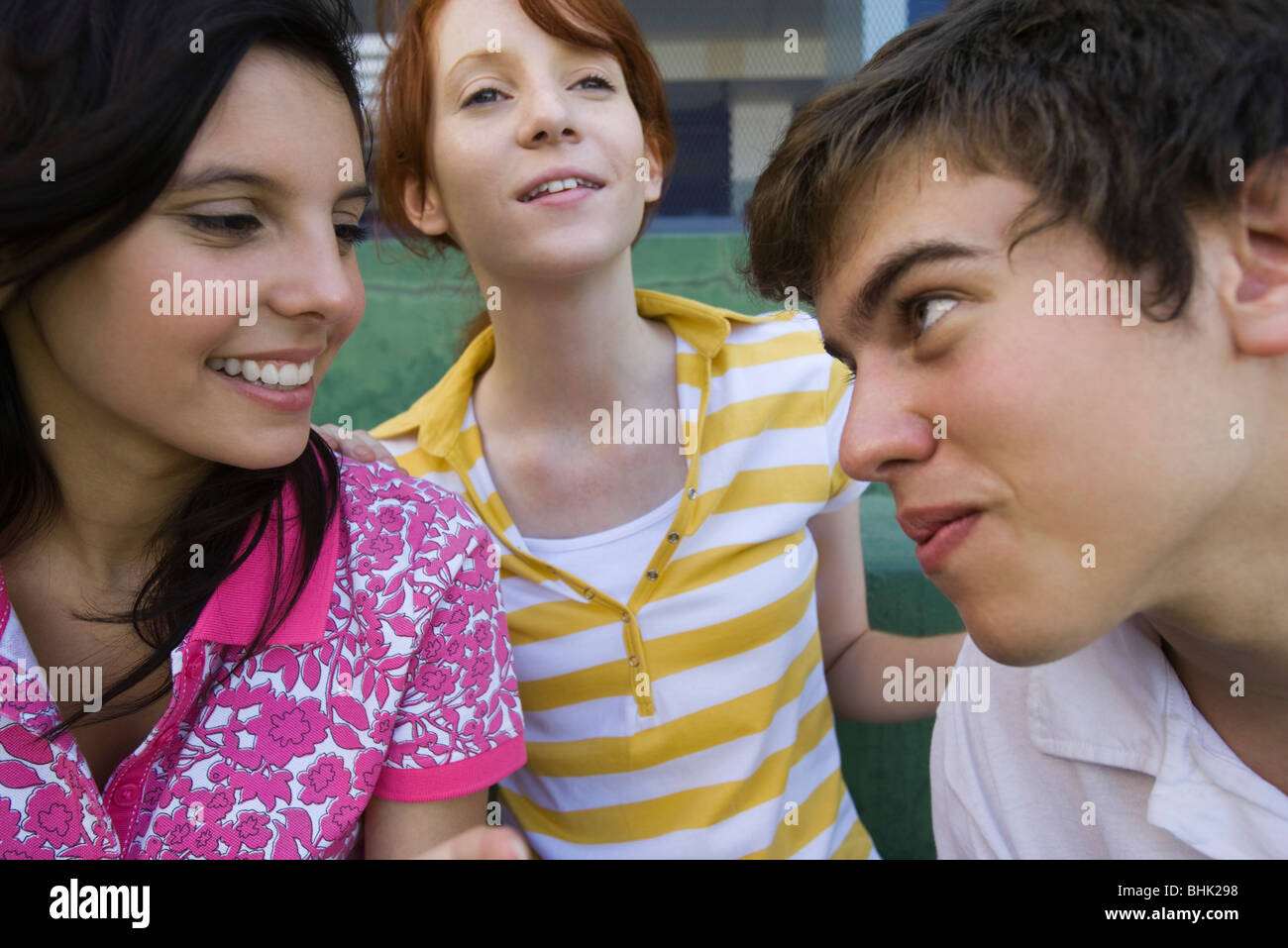 Teenage boy playfully looking at girl friend with playful expression Stock Photo