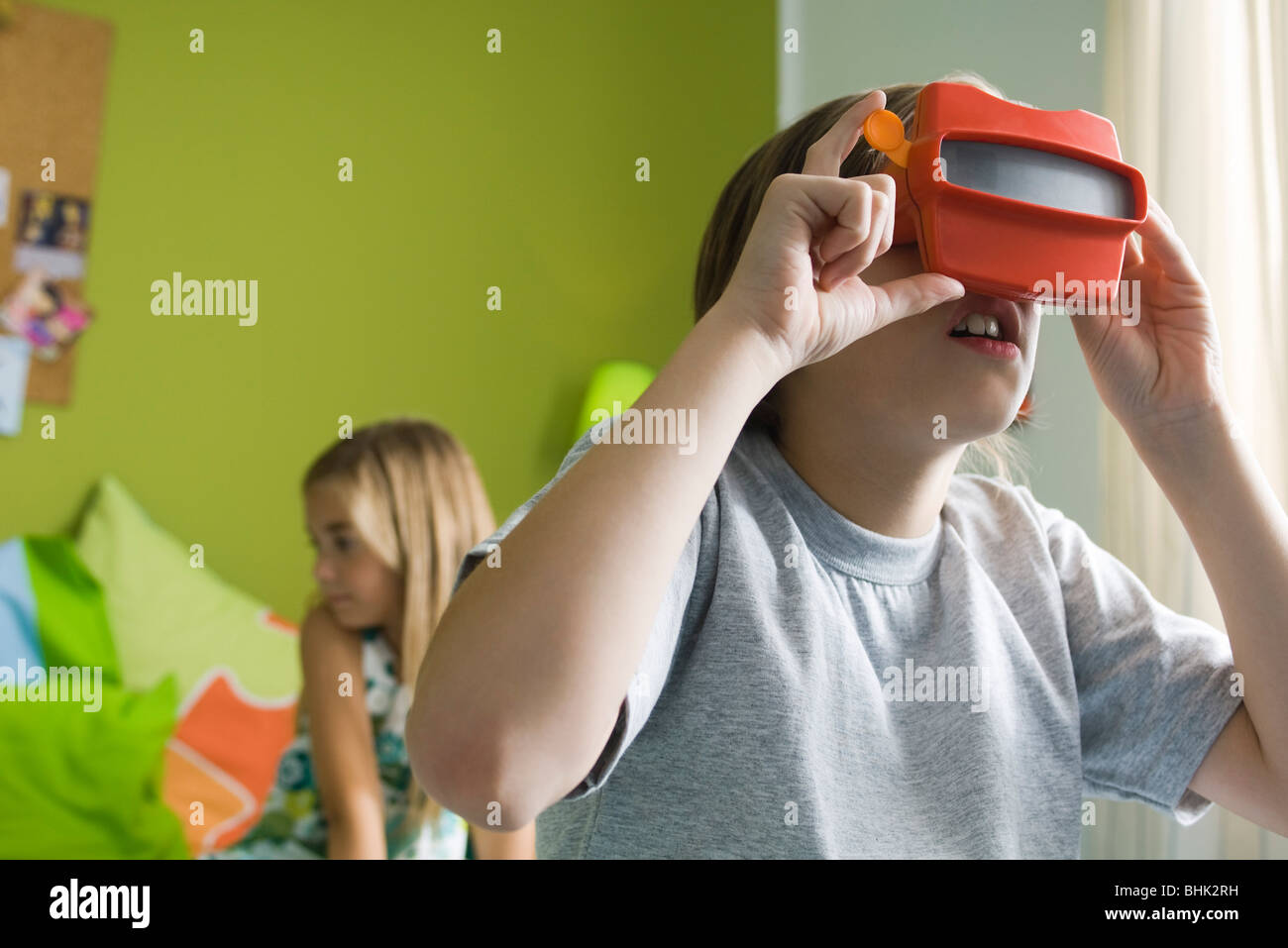 Boy looking through toy viewfinder Stock Photo Alamy
