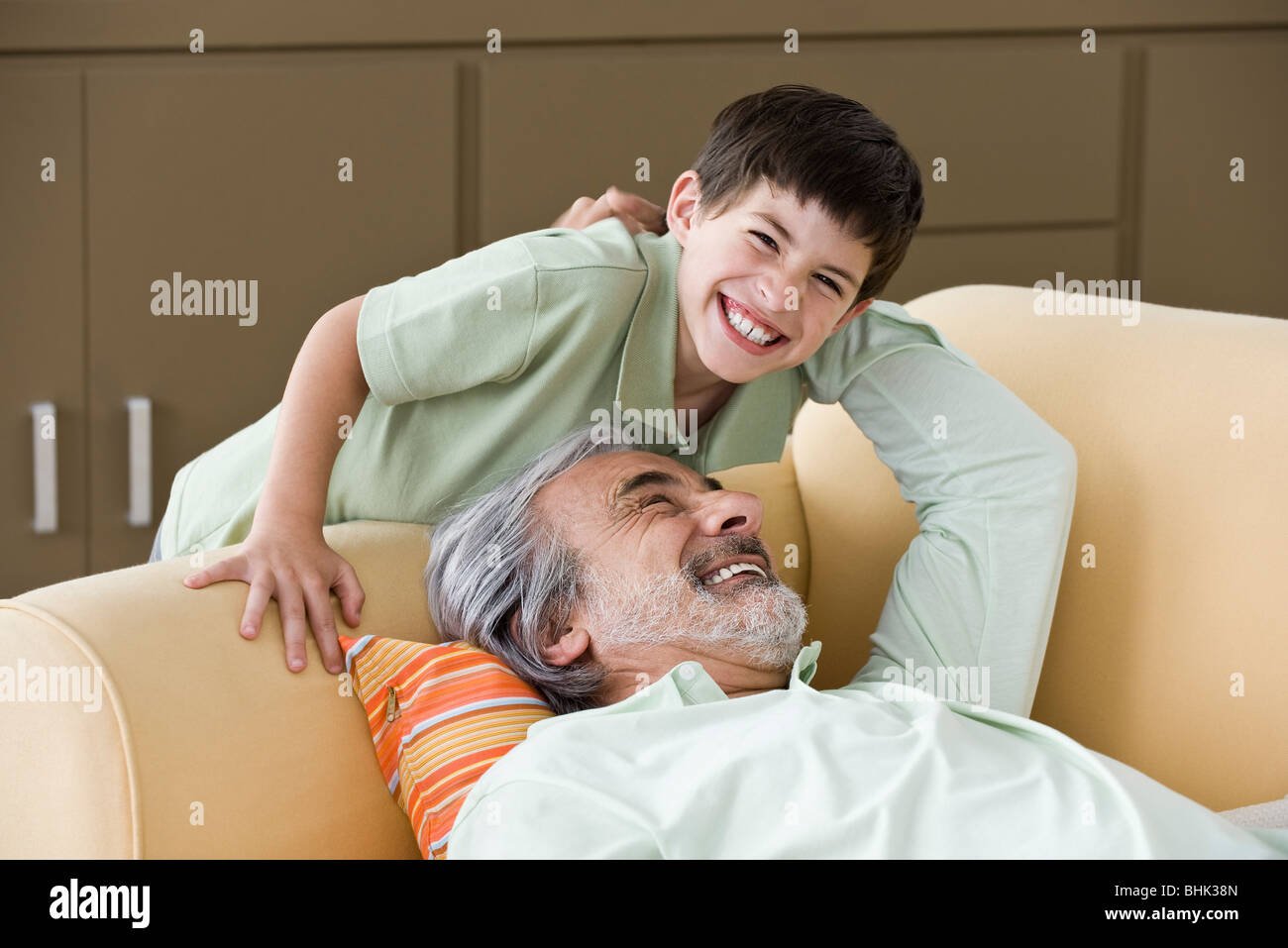 Senior man relaxing, enjoying time with young grandson Stock Photo