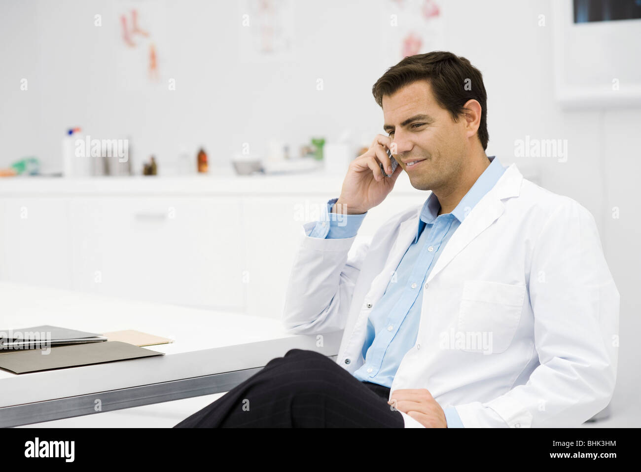 Doctor taking phone call in office Stock Photo Alamy