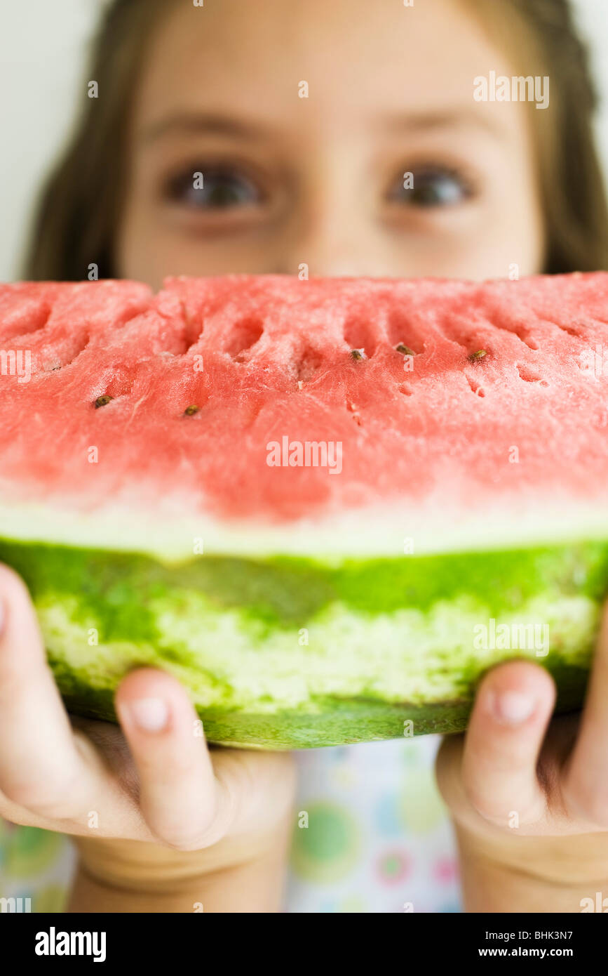 Holding up slice of watermelon Stock Photo